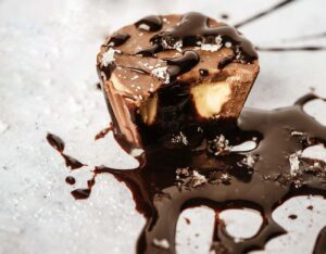 Chocolate dessert with gooey center and drizzle.