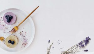 A plate with some food on it and some flowers