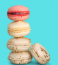 A stack of four different colored macaroons.