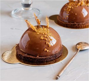 A chocolate cake with caramel on top of it.