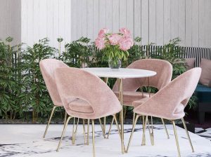 A table and chairs set up outside in the sun.