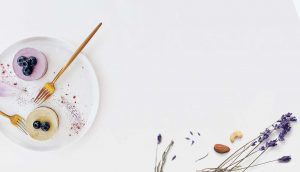 A white plate with some flowers and a brush
