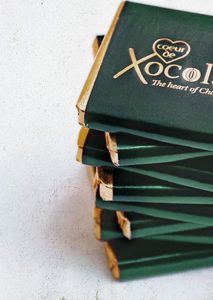 A stack of chocolate covered sticks on top of each other.