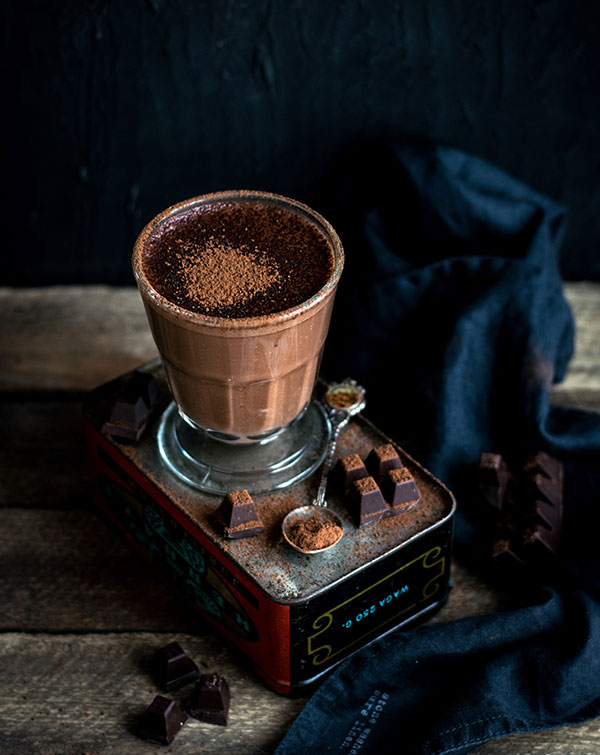 A cup of chocolate on top of a table.