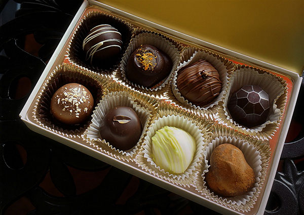 A box of chocolates with different flavors.