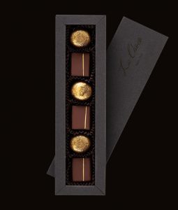 A box of chocolates with a note in the middle.