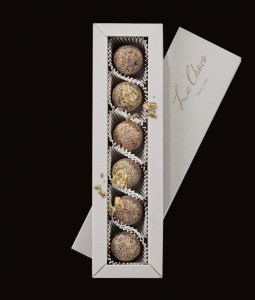A box of six cookies in the shape of balls.