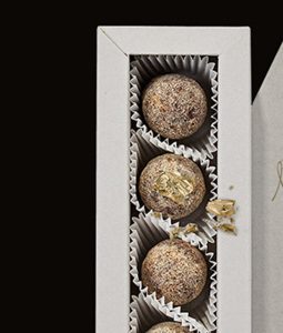 Three cookies in a box with one cookie missing.