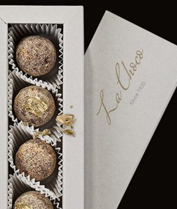 A box of three truffles with gold leaf.