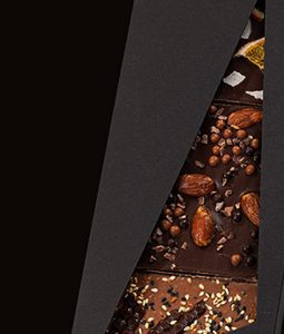 A chocolate bar with nuts and almonds on it.