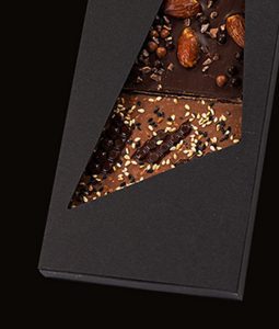 A chocolate bar with nuts and other toppings.