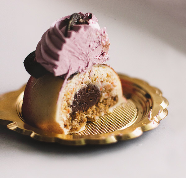 A piece of cake sitting on top of a gold plate.