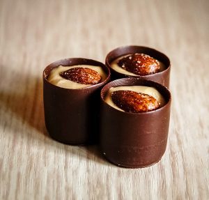 Three cups of chocolate and a small bowl
