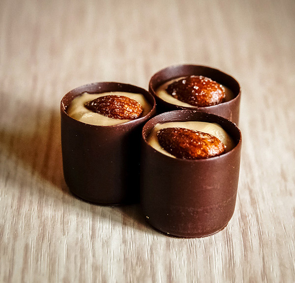 Three cups of chocolate and a small bowl