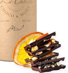 A close up of some chocolate bars next to an orange