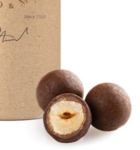 A box of three chocolate balls with one half eaten.