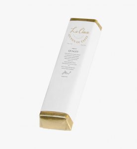 A white box with gold trim and a label.