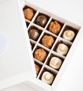 A box of chocolates with different flavors in it.