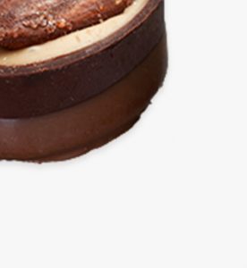 A close up of some chocolate cake on top of a table.