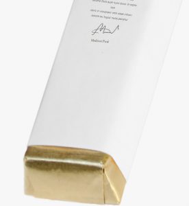 A white box with gold foil on top of it.