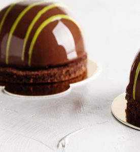 A close up of two chocolate cakes on plates