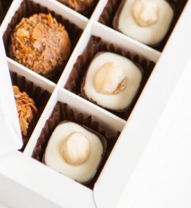 A box of cookies and candies in the middle.