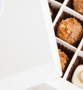 A box of cookies with one cookie missing.
