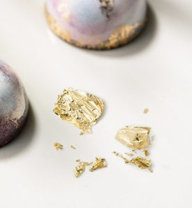 A close up of some gold flakes on top of a table