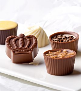 A close up of chocolate cups on a table