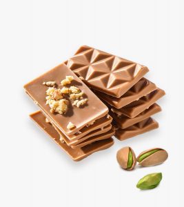 A stack of chocolate bars with nuts on top.