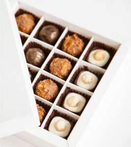 A box of chocolates with different flavors in it.
