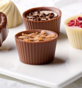 A plate with several different types of chocolate.