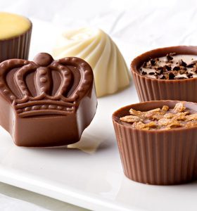 A close up of chocolate cups on a table