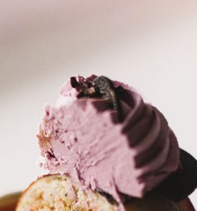 A close up of some ice cream on top of a cupcake