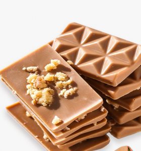 A stack of chocolate bars with nuts on top.