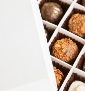 A close up of some chocolates in a box