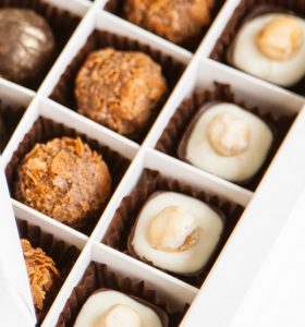 A box of chocolates with different flavors in it.