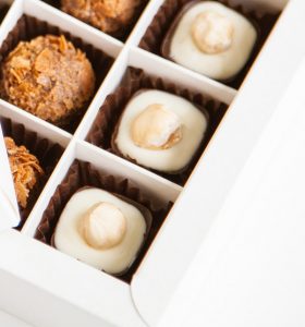 A box of chocolates with different flavors in them.