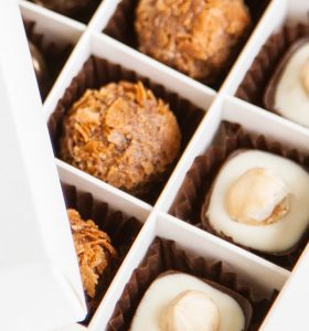 A close up of some chocolates in a box