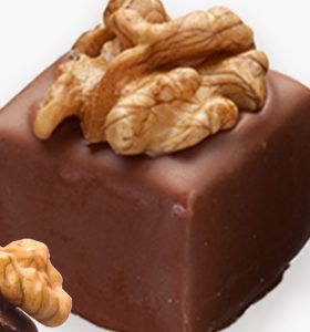 A square chocolate cake with walnuts on top.