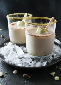 Two glasses of ice cream sitting on a tray.