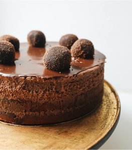 A chocolate cake with truffles on top of it.