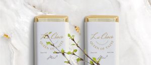 Two boxes of chocolate with a branch in the middle.