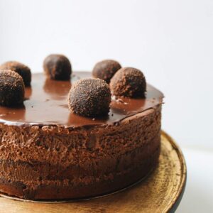 Chocolate cake with truffles on top.
