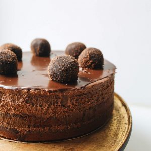 A chocolate cake with some truffles on top of it