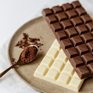 A plate with three different types of chocolate.