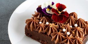 A close up of a cake with flowers on top