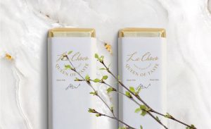 Two boxes of chocolate with a branch in the middle.