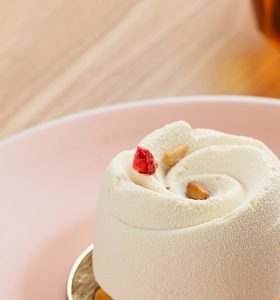 A close up of a cake with white frosting