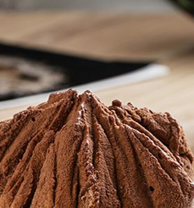 A chocolate ice cream cone sitting on top of a table.